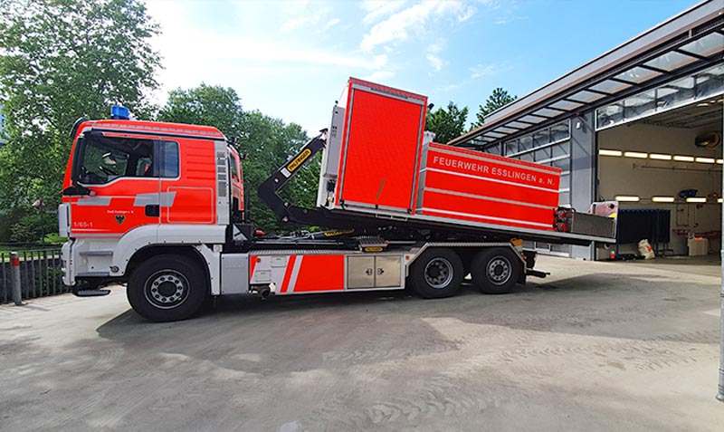Fahrzeugbeschriftung der Abladecontainer der Feuerwehr Esslingen in Tagesleuchtfolie und Warnstreifen